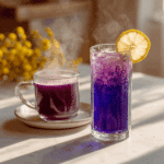 Brazilian Mounjaro Drink in glass with lemon and pea flowers