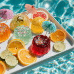 Colorful pool party jello shots with sprinkles by the pool