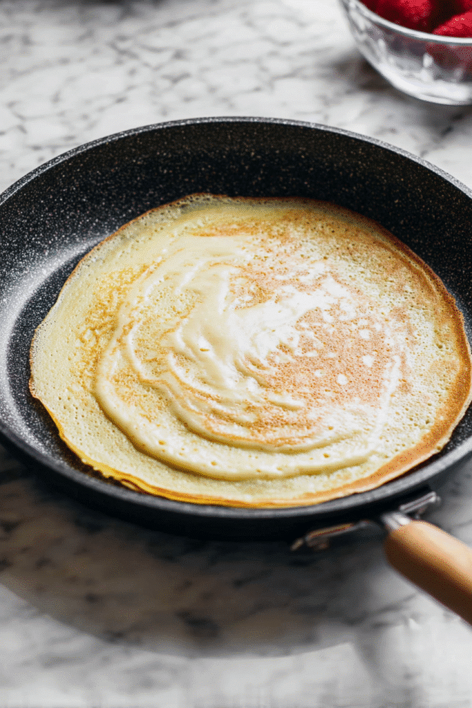 Cooking a thin golden crêpe in non-stick pan