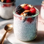 Chia pudding with yogurt in jar topped with berries