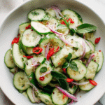 Asian Cucumber Salad top-down view in a white bowl for recipe card
