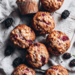 Top-down view of Moist Bakery Style Banana Blackberry Muffins and recipe card