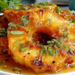 Hero shot of Rum-Soaked Grilled Pineapple with caramelized rings and toasted coconut flakes