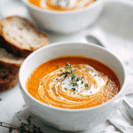 Top-down view of Vegan Carrot Potato Soup with cashew cream and thyme