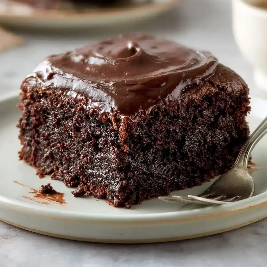 Delicious slice of buttermilk chocolate cake topped with frosting.
