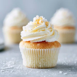 Bakery-style soft vanilla cupcakes on a decorative plate