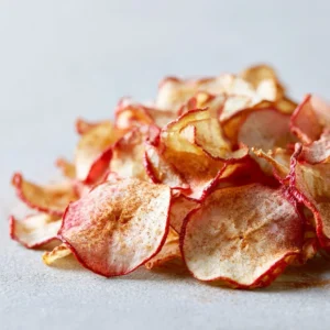 Homemade apple cinnamon chips on a baking tray, ready to enjoy.